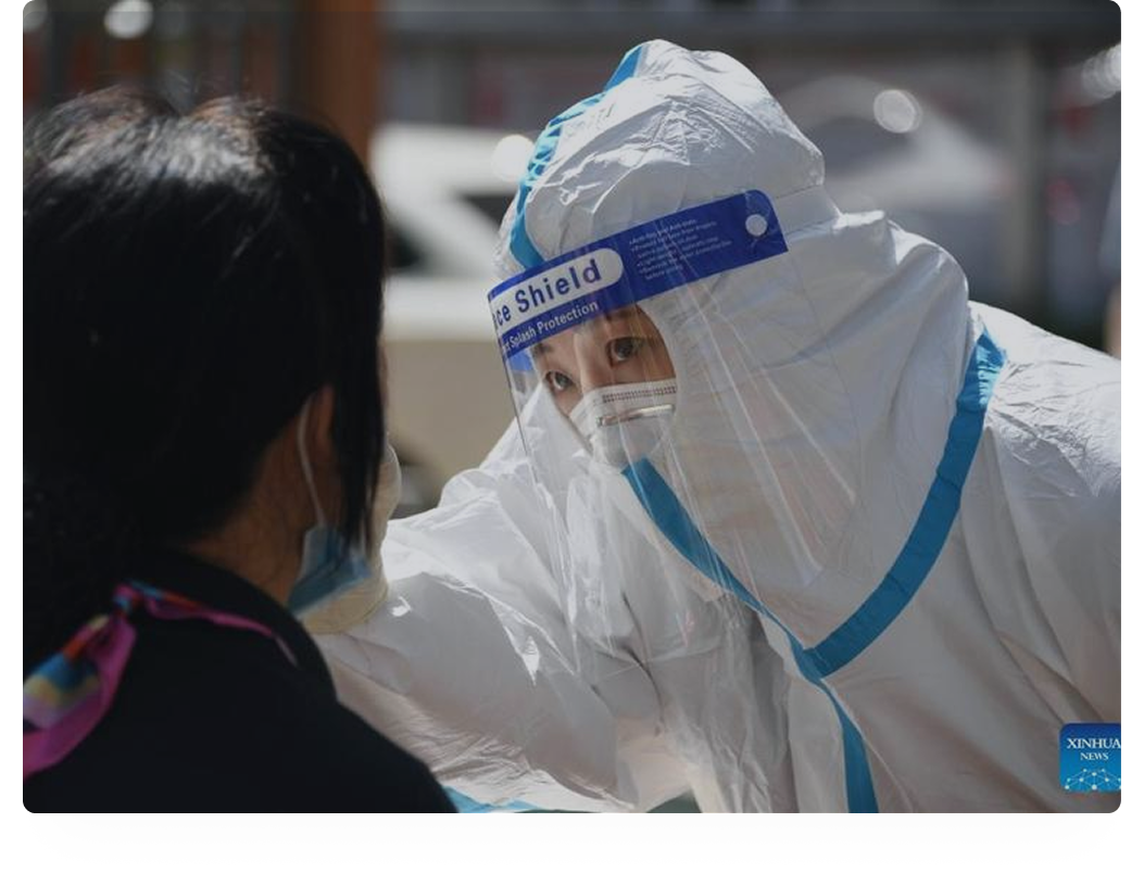 Health worker in protective equipment conducting field screening